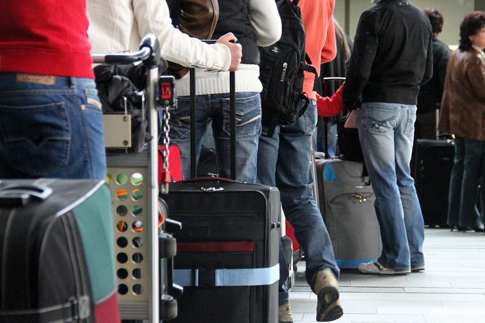 Touristen beim Check-in am Flughafen